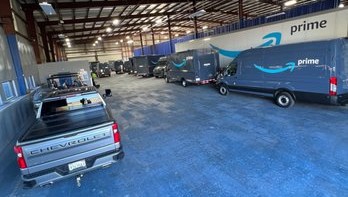 Amazon delivery vans and fleet vehicles lined up in the shop
