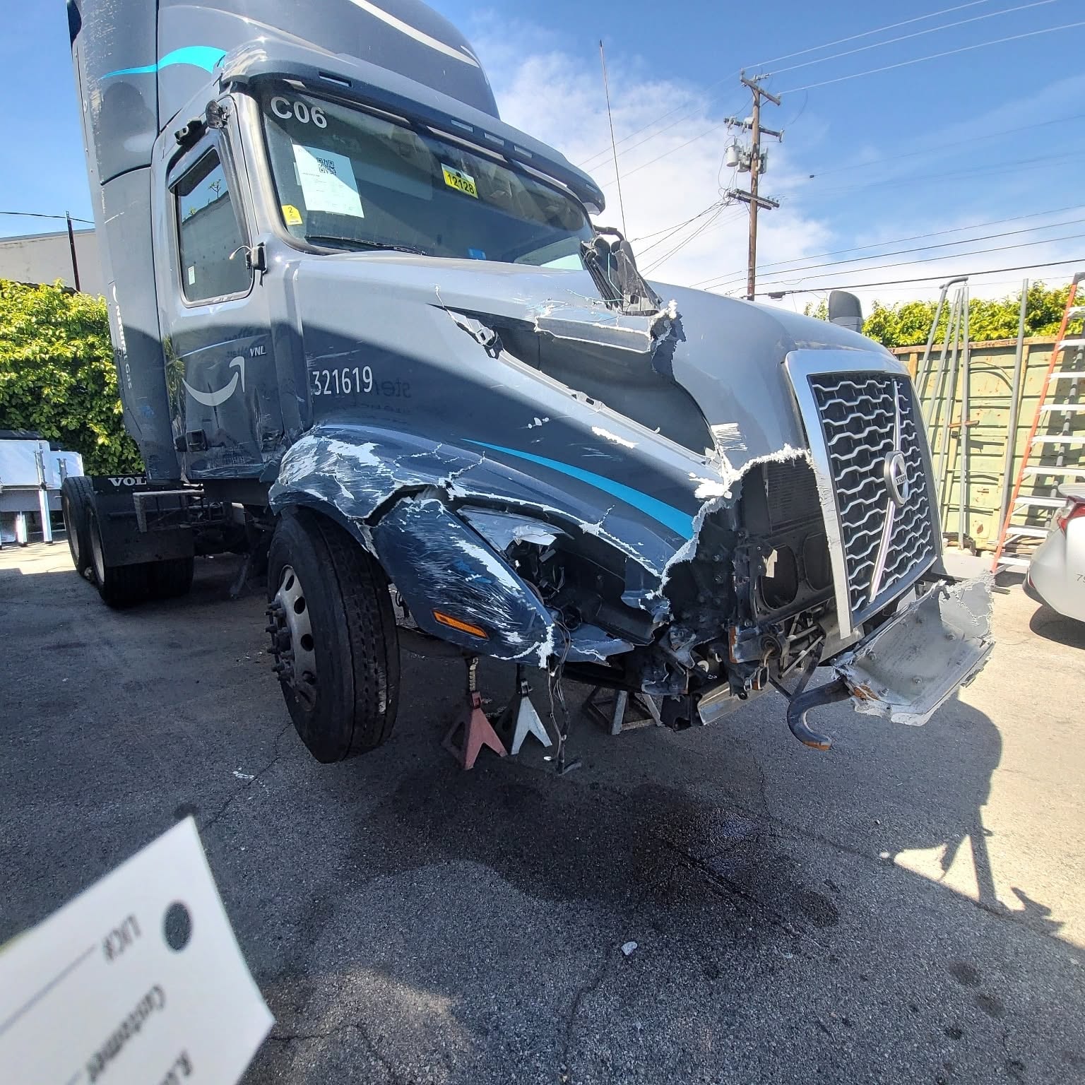Amazon Volvo VNL semi-truck with heavy front-end collision damage