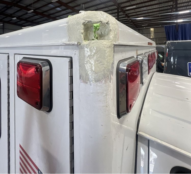 Ambulance corner being rebuilt with body filler in the shop